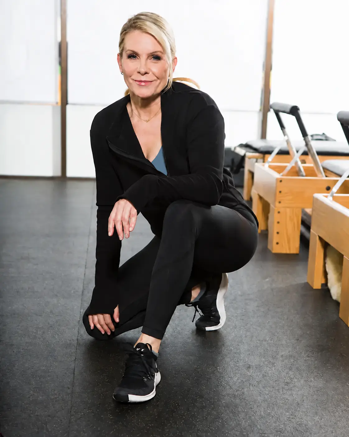 Noelle Rox seated in a Pilates studio