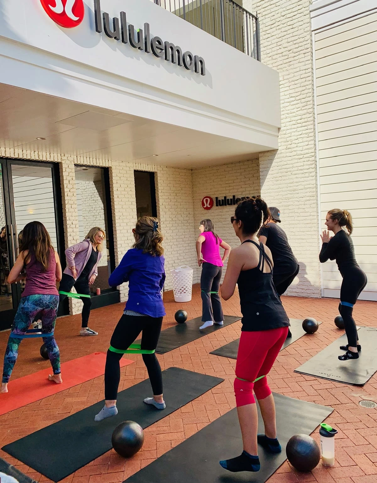 Noelle Rox leading a group Pilates class outdoors